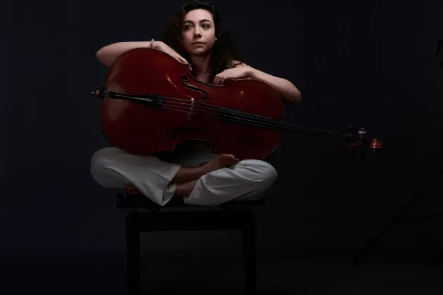 Musician with sitting with cello. Photo. 